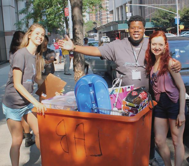 three students moving into the residence hall